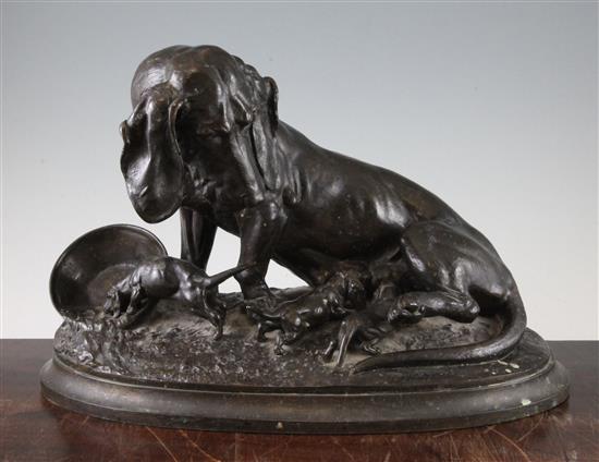 A late 19th century figure group of a female bloodhound and puppies, 11in.
